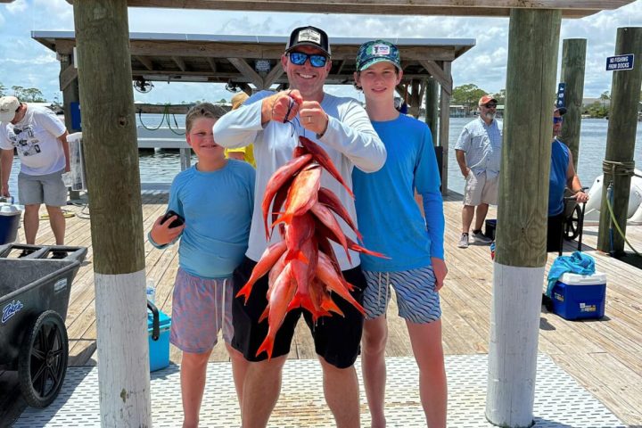 a group of people standing on a sidewalk