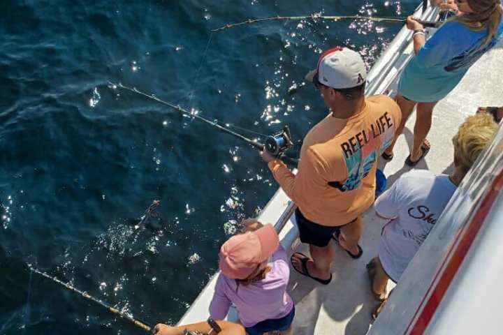 a person riding on the back of a boat in a body of water
