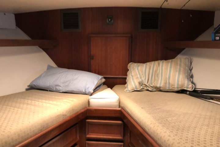 a bedroom with a bed and desk in a room