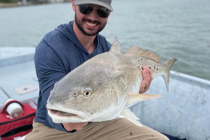 a person holding a fish in the water