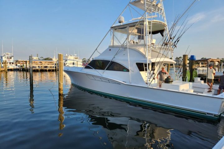 a boat is docked next to a body of water