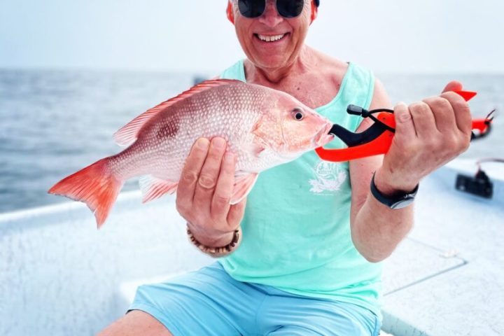 a person holding a fish in the water