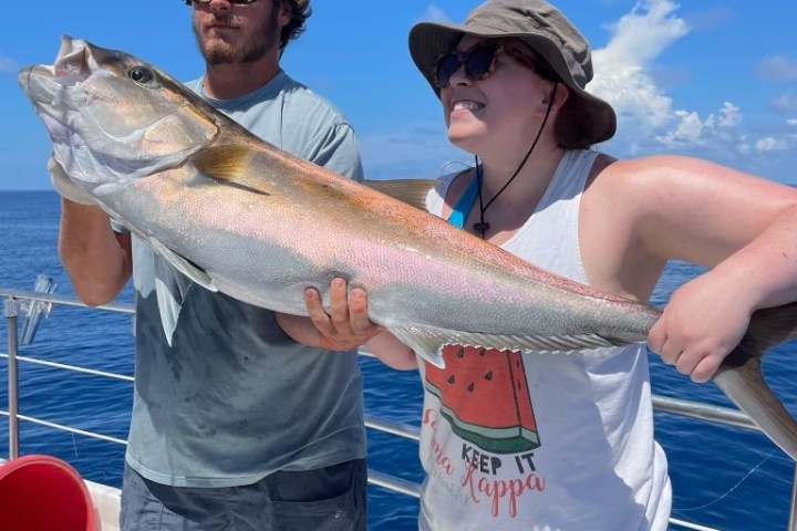 a man holding a fish