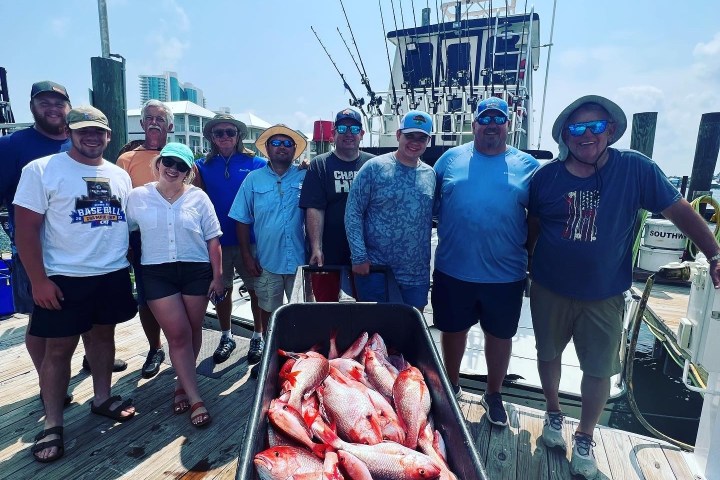 a group of people standing on a boat