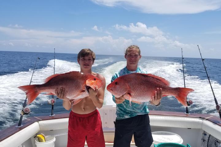 a man holding a fish in the water