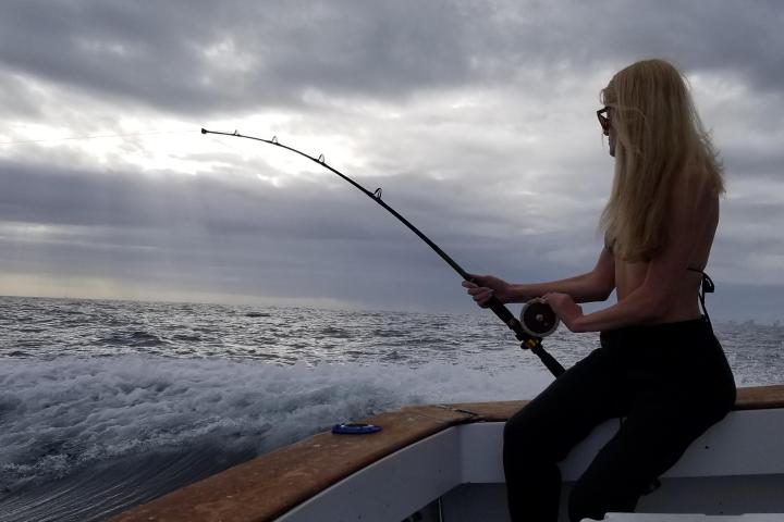 a person standing next to a body of water