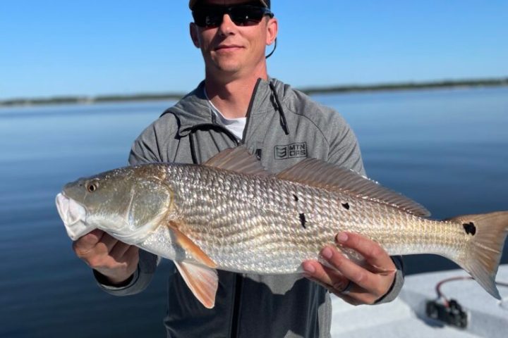 a person holding a fish