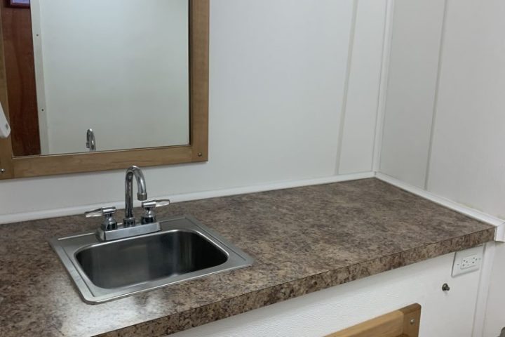 a kitchen with a sink and a mirror