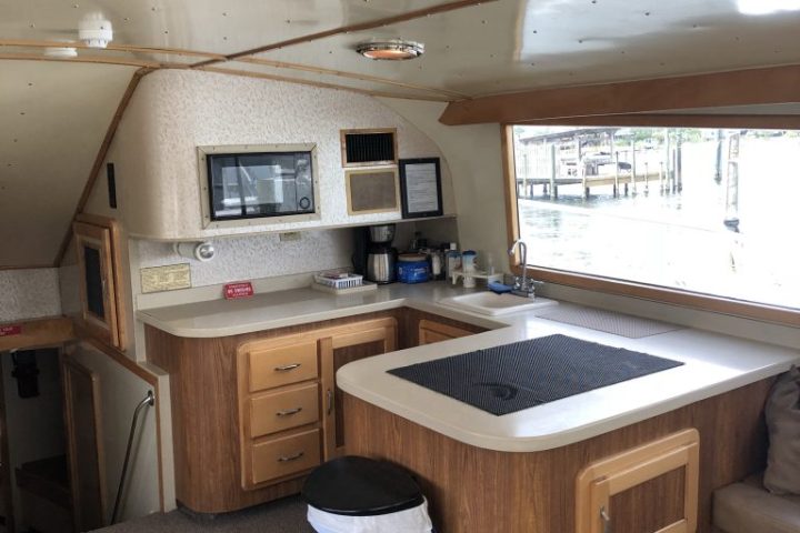 a kitchen with a stove top oven sitting inside of a room