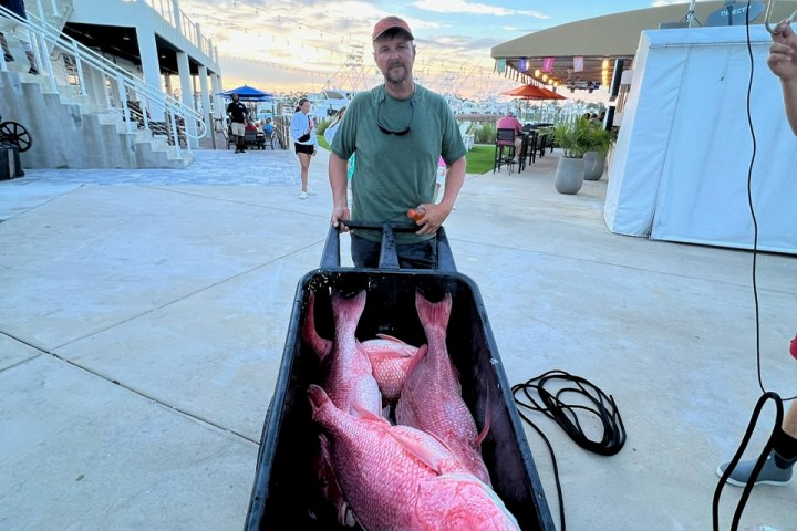 a person standing next to a boat