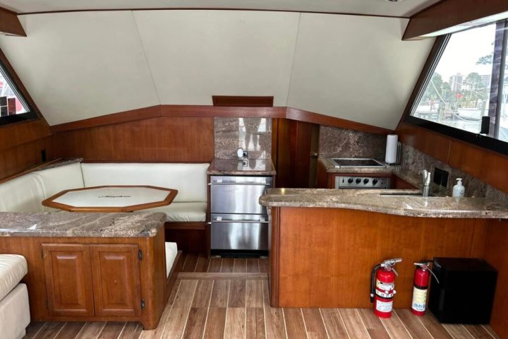 a kitchen with wooden cabinets and a large window