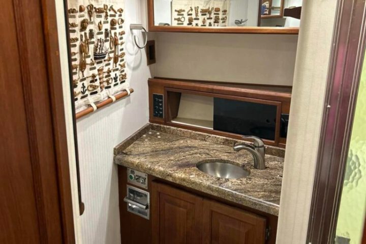 a kitchen with a sink and a mirror