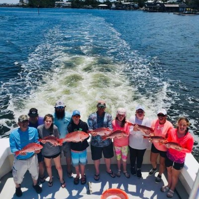 a group of people standing next to a body of water