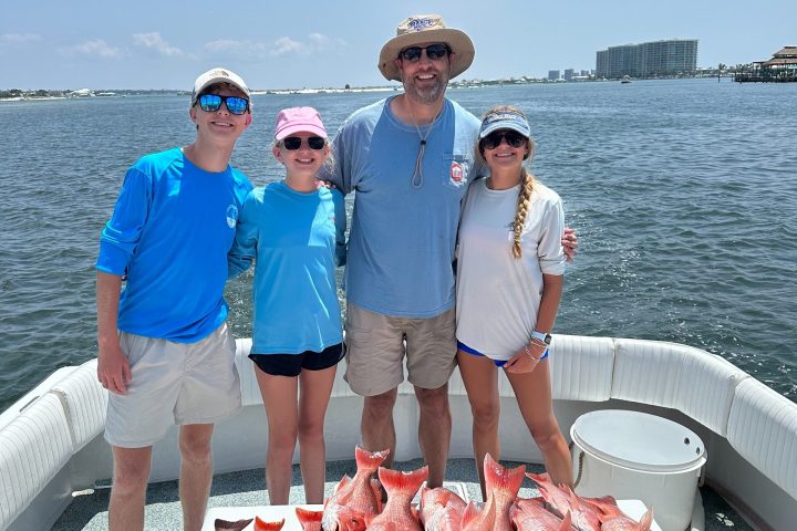 a group of people standing next to a body of water