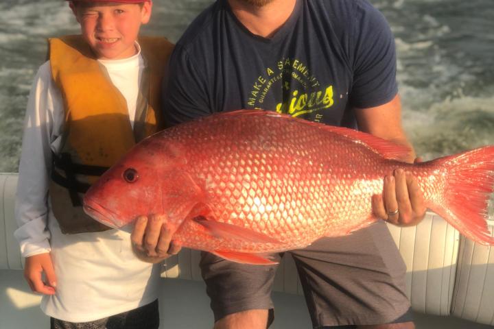 a man holding a fish