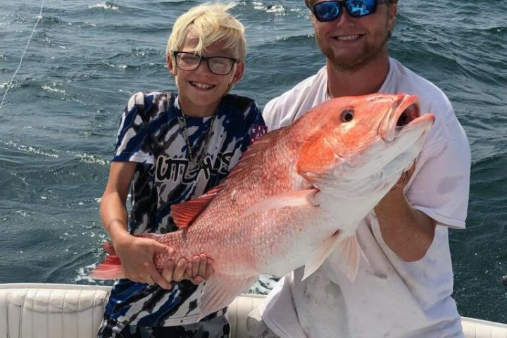 a person holding a fish in the water