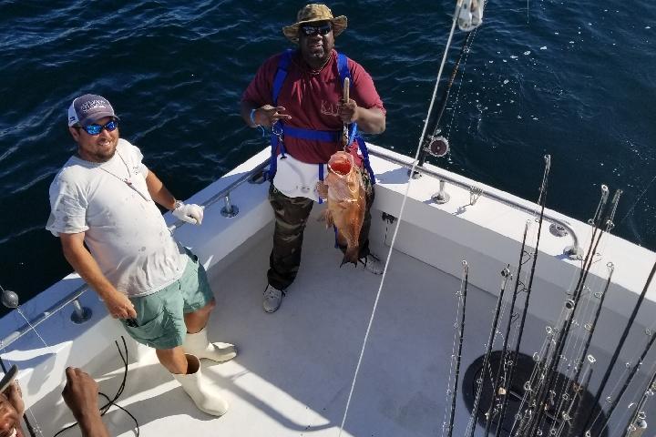 a man riding on the back of a boat in the water
