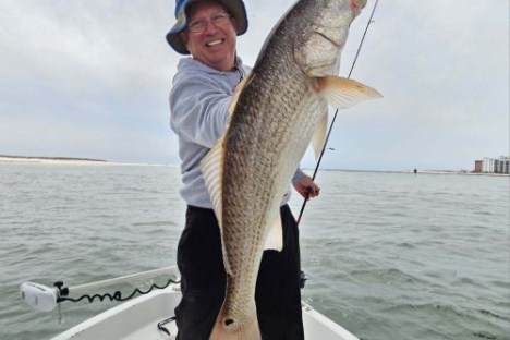 a man holding a fish in the water