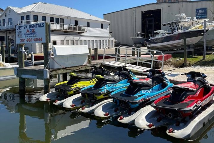 a small boat in a body of water with a city in the background