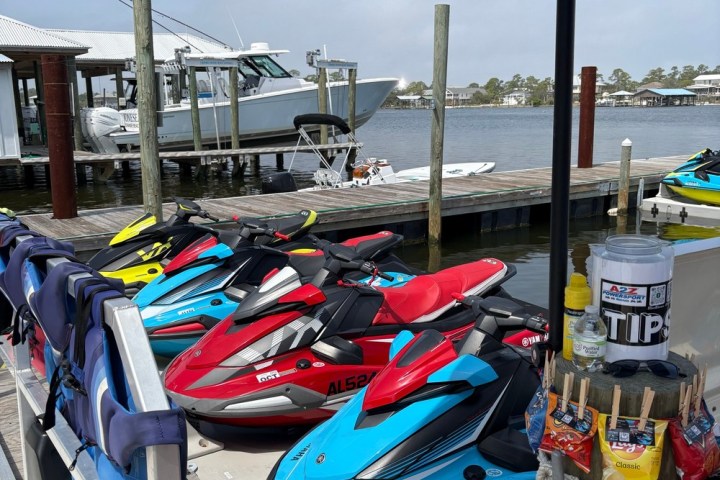 a row of beach chairs and an umbrella