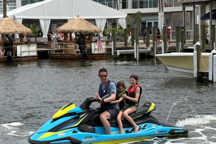 a person riding on the back of a boat in the water