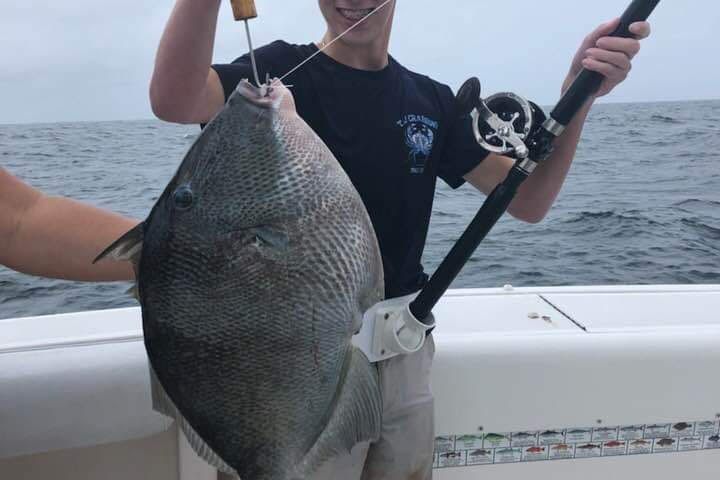 a person holding a baseball bat standing in the water
